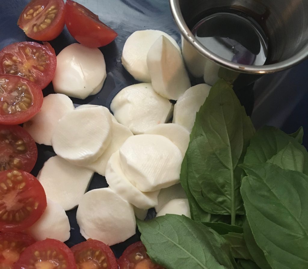 Cut tomatoes and fresh mozzarella. Tear the basil leaves.